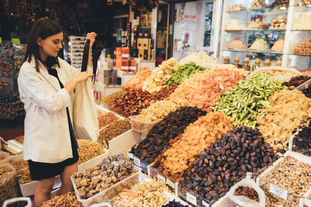 istock Woman on bazaar exploring spices, nuts and delight. 1467115789