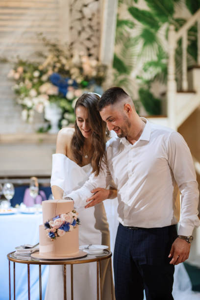 istock newlyweds happily cut and taste the wedding cake 1467116147
