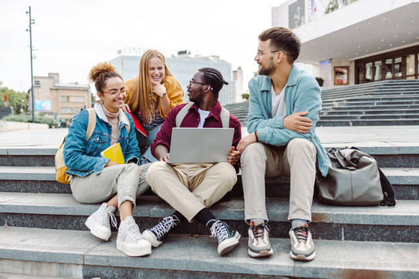 istock Hanging out on campus. Young group of students using laptop 1467116244