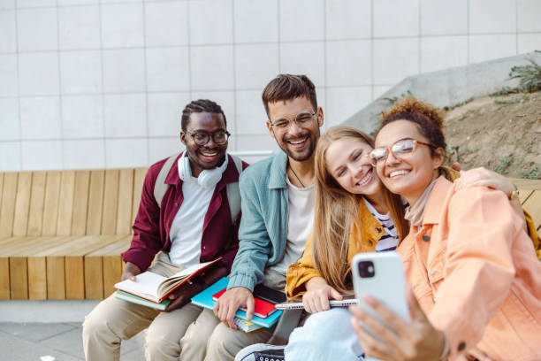 istock Group of students taking selfie and smiling 1467116248