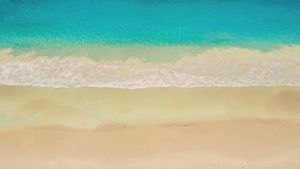 istock Beach and azure sea with waves from top view. 1467118393