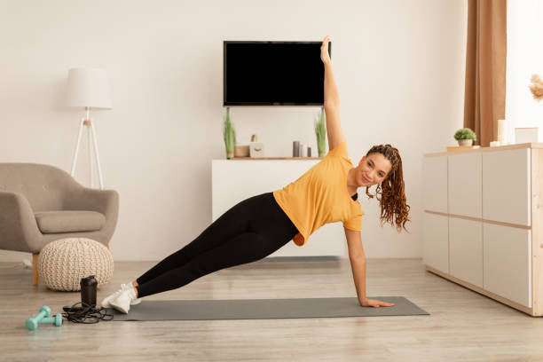 istock African Female Exercising Doing Side Plank Raising Arm At Home 1467118877