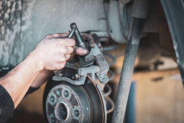 istock Man hand Brake pad replacement in car service 1467123631