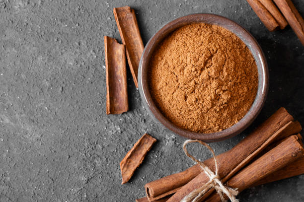 istock Cinnamon sticks and cinnamon powder on dark rustic background, healthy spice, (Cinnamomum) 1467123831