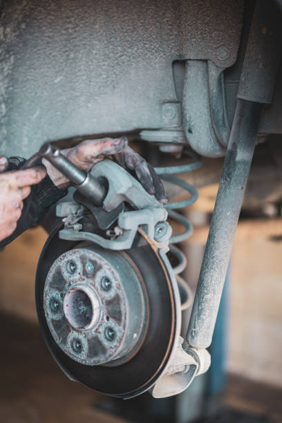 istock Man hand Brake pad replacement in car service 1467123903