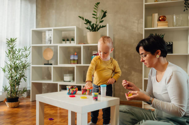 istock Mother and son molding a clay at home and having educational act 1467124337
