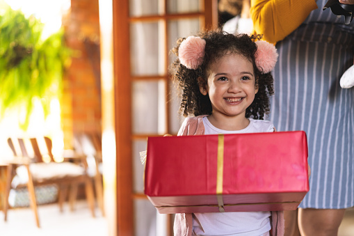 Small child holding a red gift box