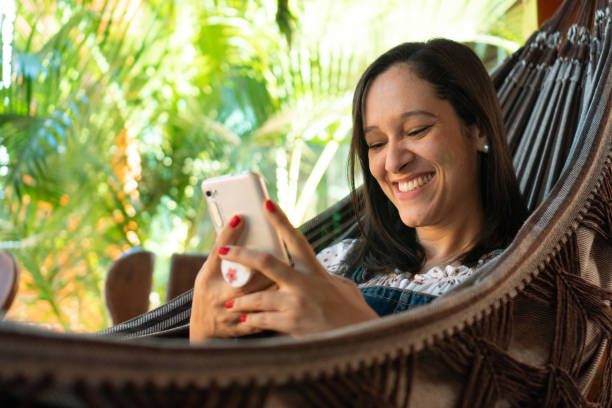 istock Woman on video call relaxing in hammock 1467127367