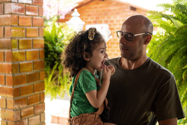 istock Father holding daughter in arms 1467127864