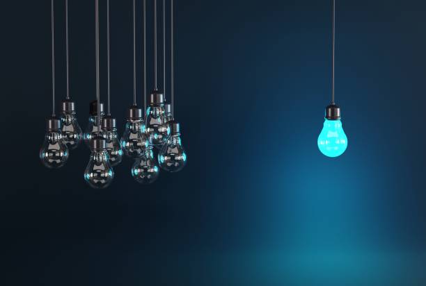istock One light bulb on the background of many extinguished light bulbs. 1467133490