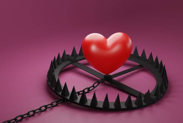 istock Heart over a snare, a trap on a dark background. 1467133818