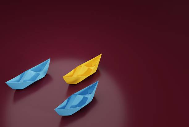 istock Paper ships sailing in one direction. 1467134223