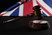 Judge's gavel against the background of the UK flag.