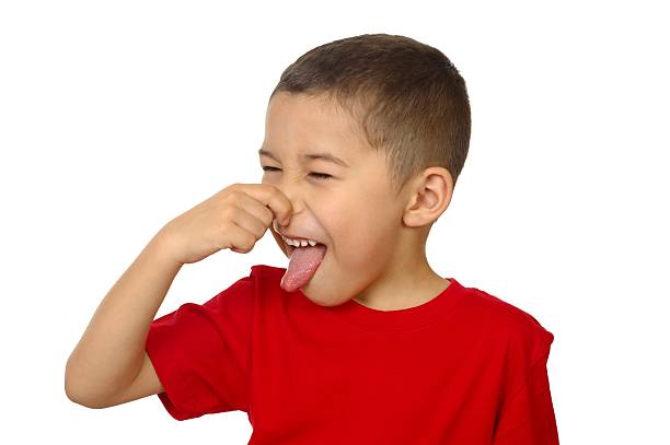 kid smelling a bad odor horizontal portrait of a seven-year-old boy reacting to a stinky smell, isolated on white background holding nose stock pictures, royalty-free photos & images