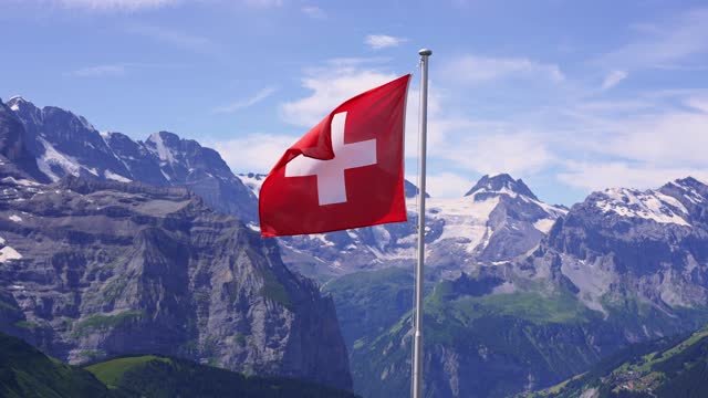 Swiss flag in Bernese Oberland, one of Switzerland most popular destinations for tourists.