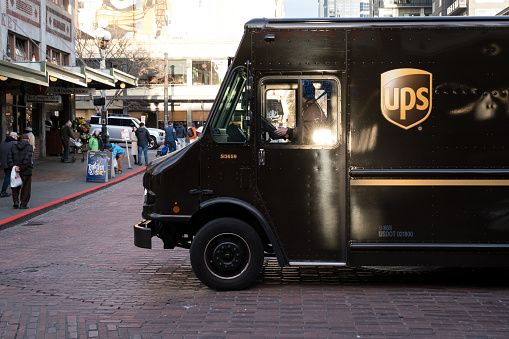 Seattle, USA - Feb 1, 2023: UPS delivering on Pike Street across from the Pike Place Market late in the day.