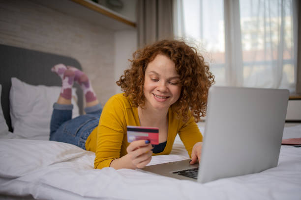 istock Cheerful  young woman doing online shopping 1467139876