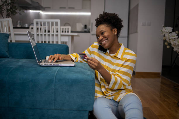 istock Cheerful  young woman doing online shopping 1467139906