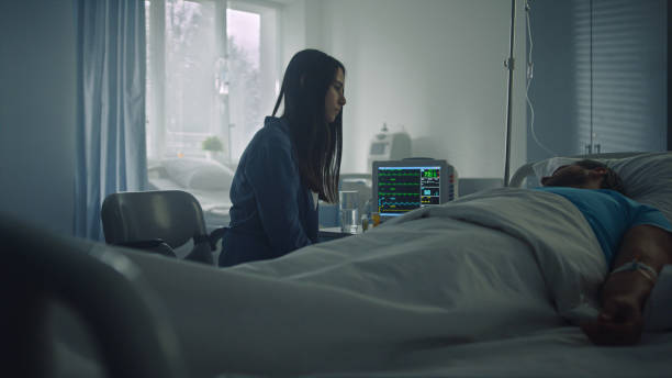 Woman comfort sick man in hospital ward. Modern clinic operating room interior. Woman comfort sick man in hospital ward. Modern clinic operating room interior. Beautiful wife visit ill husband gently touch stroking patient after surgery. Unexpected illness family support concept. unusual couple stock pictures, royalty-free photos & images