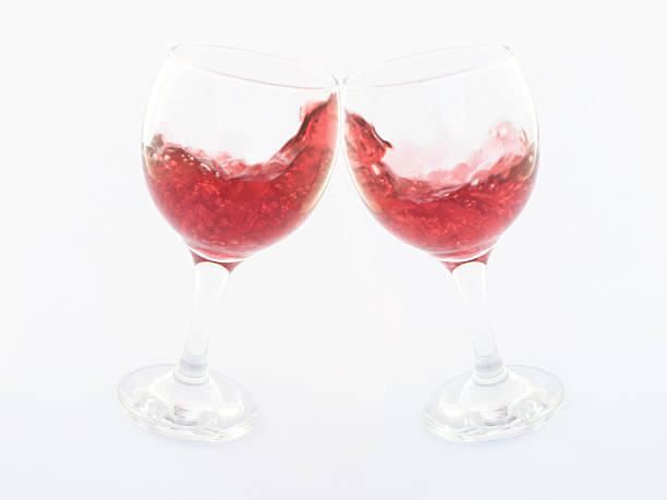 Two clinking glasses with red wine stock photo