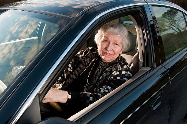 Very old woman, 86, driving her automobile stock photo