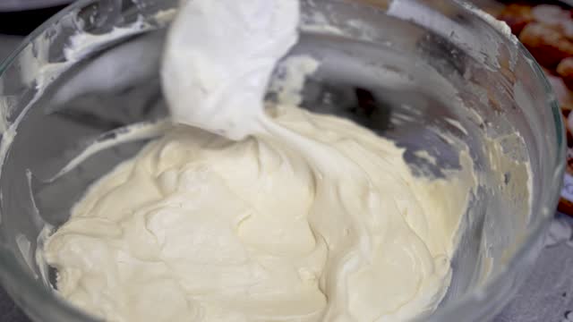 Spatula Stirring Cake Batter Or Cream In Glass Bowl. Close Up, Slow Motion