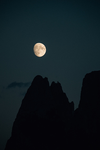 Moon over hills in Dolomites, Italy