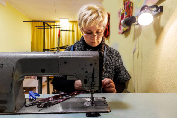 istock Photo of a female tailor at work on a sewing machine. 1467147773