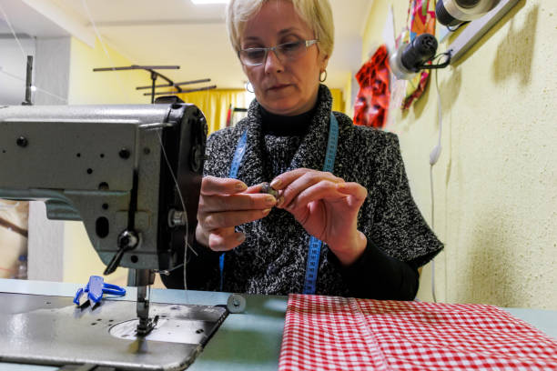 istock Photo of a female tailor at work on a sewing machine. 1467147957