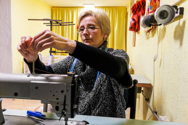 istock A woman tailor works at a sewing machine. 1467148151