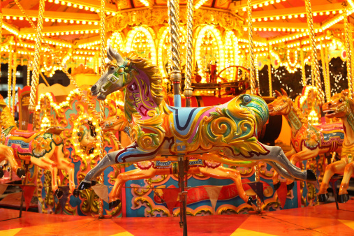 horse from colorful carousel with lights at night 