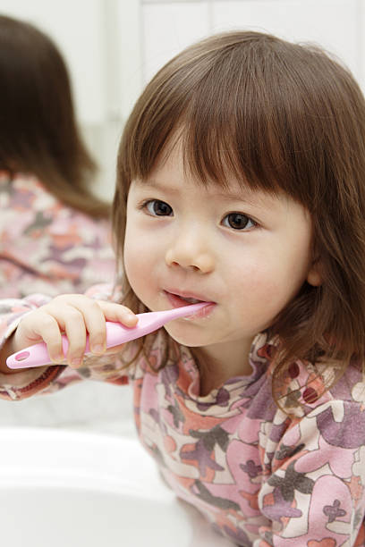 istock Little girl brushing teeth 146715395