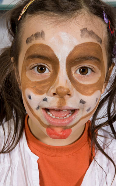 istock Young girl with a painted dog on her face 146715435