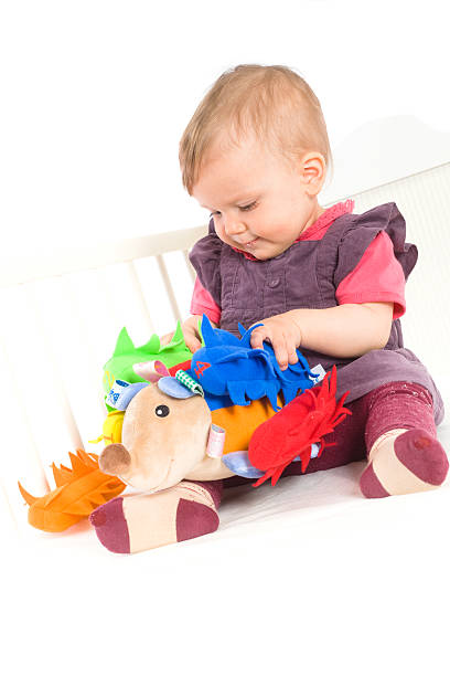 istock Baby playing with soft toy 146715557