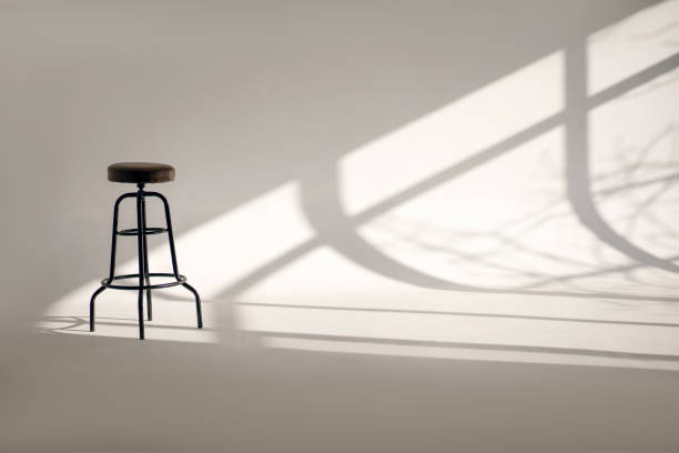 istock A white room with a shade from the sun through the window and one high bar stool 1467156441