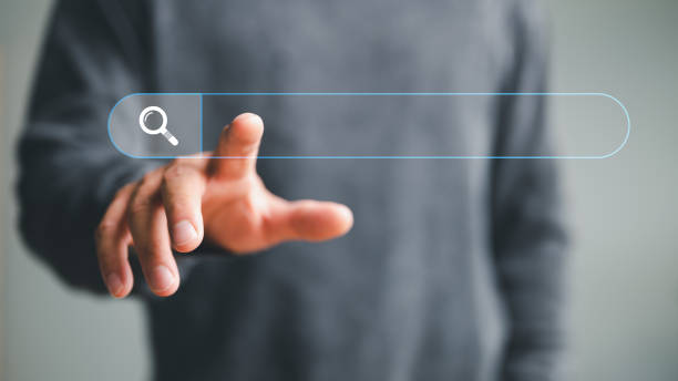 istock man hand touching on search bar for Search Engine Optimization or SEO concept to find information or data by internet connection. internet, network, database, information system. 1467161857