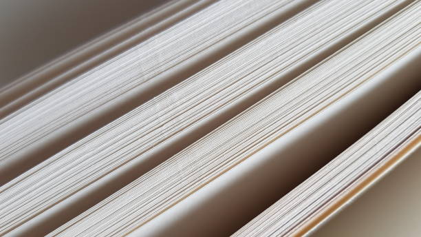 istock white blank sheets of thick notepad paper, half opened end view 1467163950