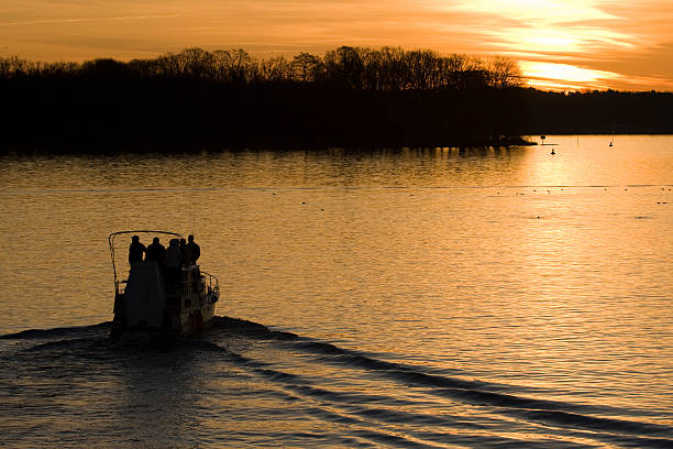 Yacht drive into the sunset stock photo