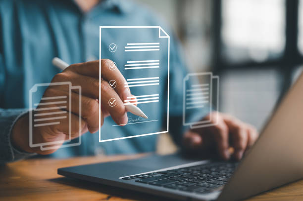 istock E-document management Paperless workplace, e-signing, electronic signature, document management man signs an electronic document on digital document by virtual notebook screen using a stylus pen. 1467171028