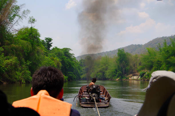 Kanchanaburi Thailand- May 4, 2016: This is the Kwai River in Kanchanaburi Province, Thailand.You can go down the river on a raft. You will be towed upstream by a boat. From there, let the river flow and slowly descend. Very quiet.It is a valuable experience not found in everyday life.Jungle along the river. You can see unusual fruits and trees.You can also experience elephant trekking near the dock.