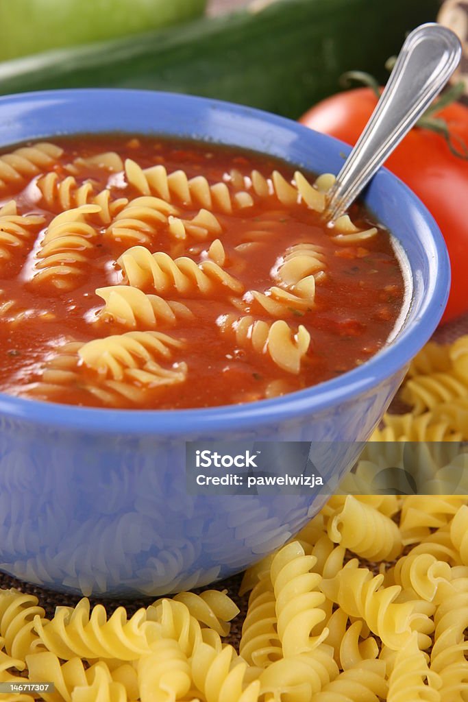 Tomato soup with pasta Tomato soup in blue bowl with pasta Arranging Stock Photo