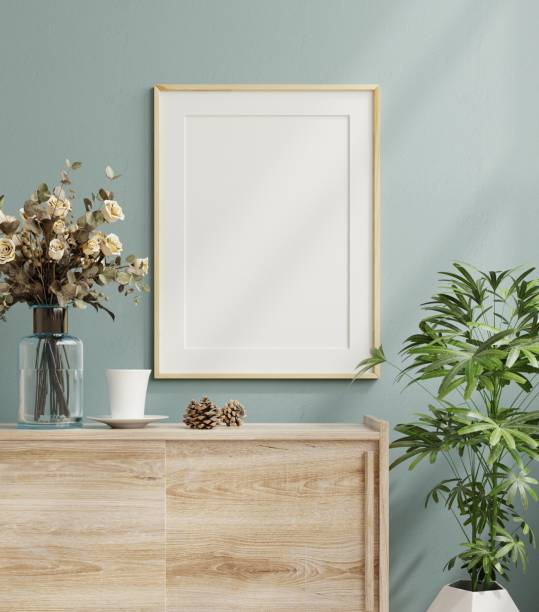Mockup frame on cabinet in living room interior on empty dark blue wall background.