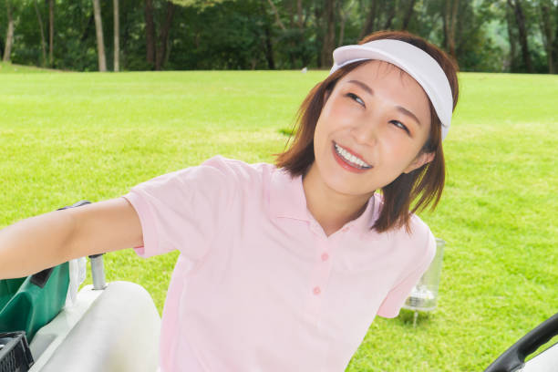 A female golfer giving a golf lesson at a golf course