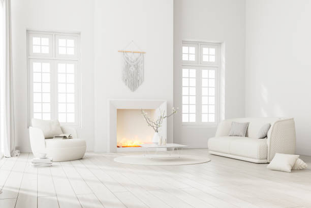 Modern style white living room Furnished with a minimal fireplace with flames and white fabric furniture 3d render stock photo