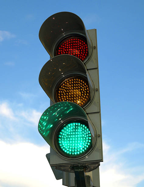 istock Close-up of a green traffic light on cloudy blue sky 146718549