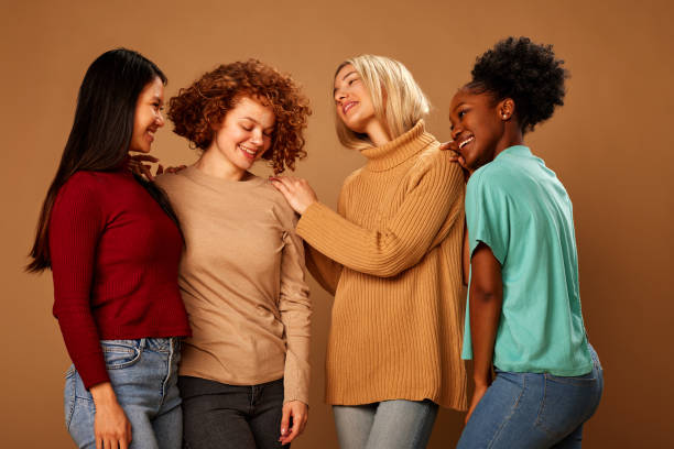 istock Four cheerful pretty multiracial girls smiling and posing in studio. 1467189346