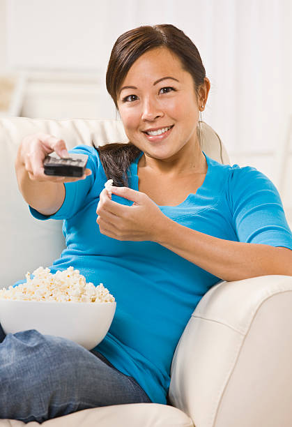 istock Beautiful Asian Woman Watching T.V. 146718960