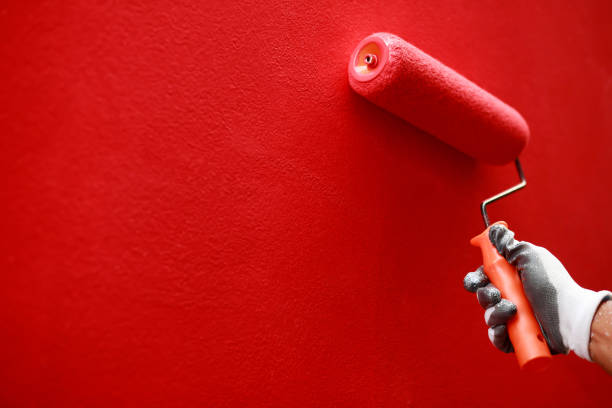 istock Painter is painting the interior wall red 1467191473