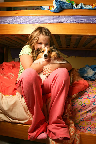 istock Young girl sitting on bed 146719616