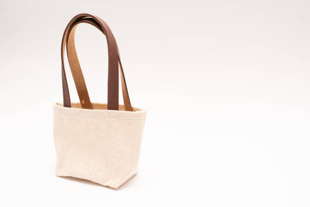 istock small full canvas bag with ties, Reusable eco bag. Empty small cotton bag with string on white background. 1467197738